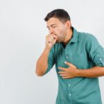 young man suffering from cough